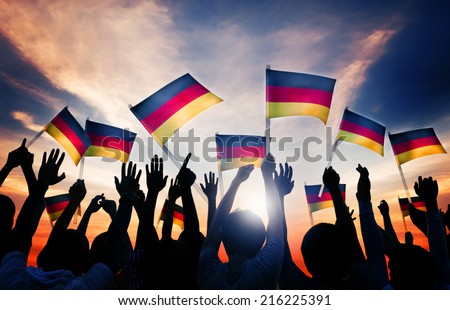 Silhouettes of People Holding Flag of Germany