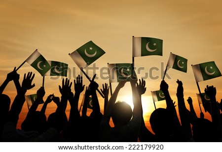 Group of People Waving Flag of Pakistan in Back Lit