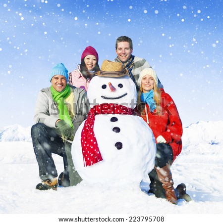 Group of friends posing with a snowman.