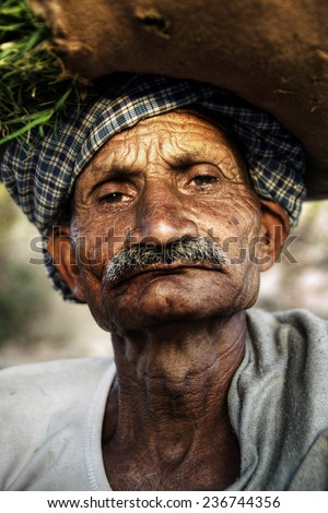 Indigenous senior Indian man looking grumpy at the camera.