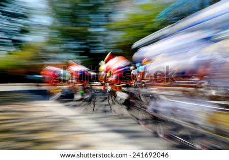 Panning shot of professional cyclists going around the final corner.