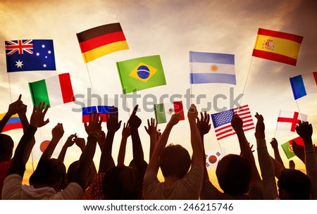 Group of People Waving National Flags in Back Lit