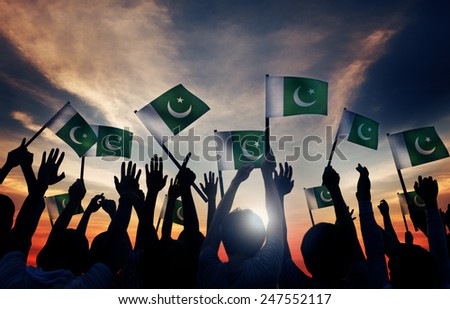 Group of People Waving Flag of Pakistan in Back Lit