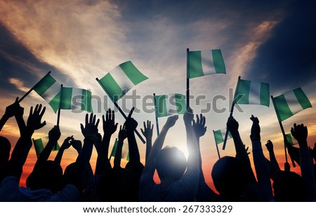 Group of People Waving Flag of Nigeria in Back Lit