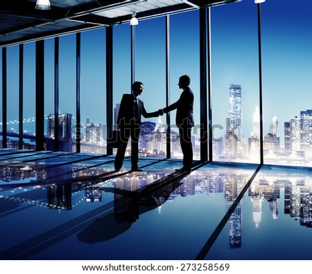 Businessmen Shaking Hands Indoors City As A Background Concept