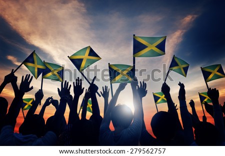 Group of People Waving Flag of Jamaica in Back Lit Concept