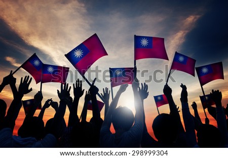 Group of People Waving Taiwanese Flags in Back Lit