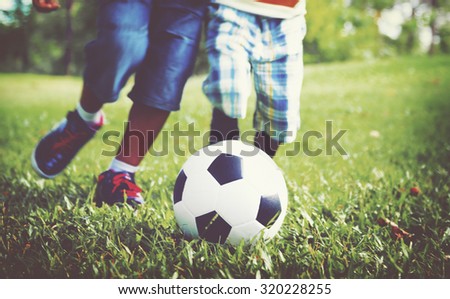 African Brother Playing Football Outdoors Concept