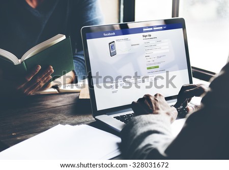 Bangkok, Thailand - October 14, 2015: Man on a Computer Browsing Facebook Website