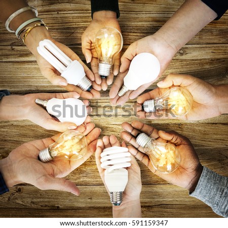 Group of hands holding creativity ideas light bulb sharing in aerial view