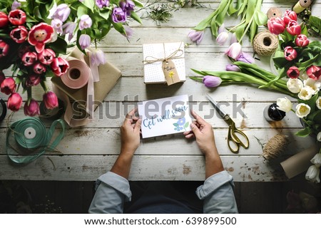 Hand Holding Show Get Well Soon Card with Tulips Flowers Background