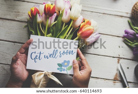 Hand Holding Show Get Well Soon Card with Tulips Flowers Background