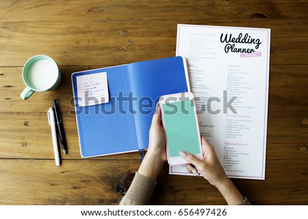 Wedding Planner Checklist Paper on Wooden Table