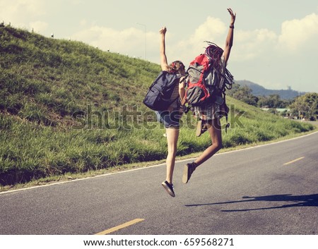 Diverse Backpacker Women Jumping The Street