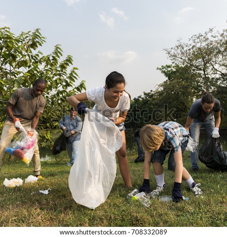 Diverse Group of People Picking Up Trash in The Park Volunteer Community Service