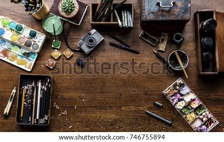 Aerial view of artistic equipments painting tools on wooden table