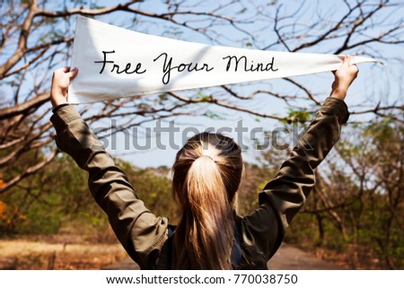 Girl holding free your mind flag banner