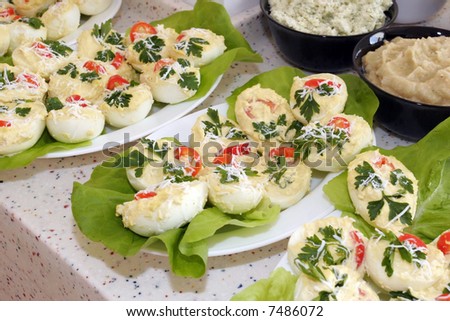 Stuffed eggs filled with cheese, mayonnaise, tomato and seasoning