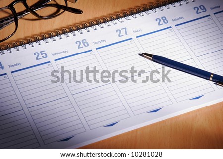 Date book on desk with glasses