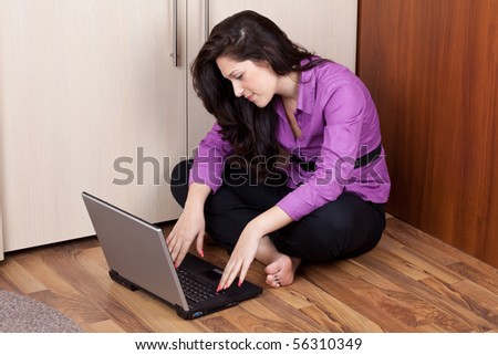young lady on the floor in purple with laptop