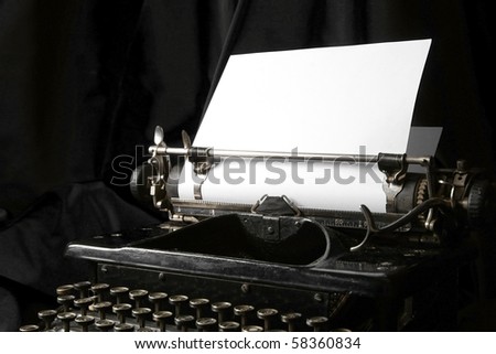 Old type writer with a blank sheet of paper