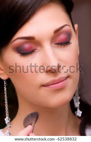 beautiful young lady closeup prepared for event by makeup artist
