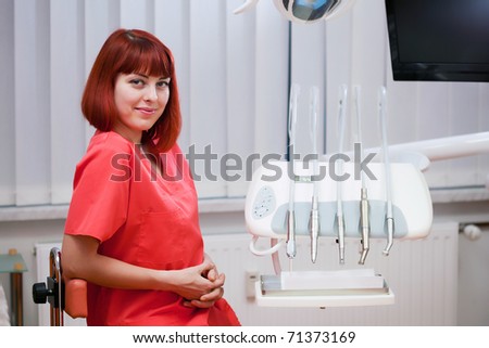 Image of young lady dentist inside the dental clicic