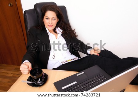 Young woman relaxing with the feet up on the desk