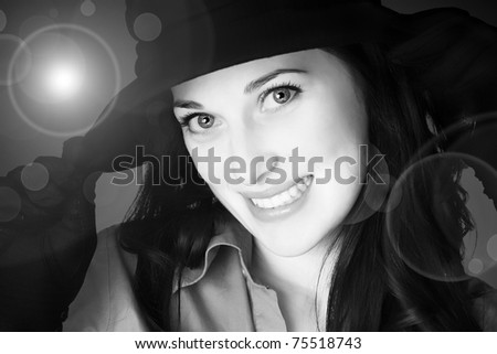 Portrait of a beautiful brunette young woman smiling with black hat and gloves