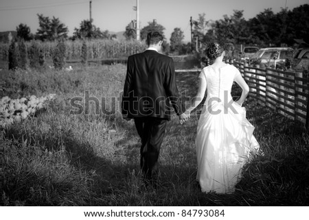 Young married couple walking on a countryside trail