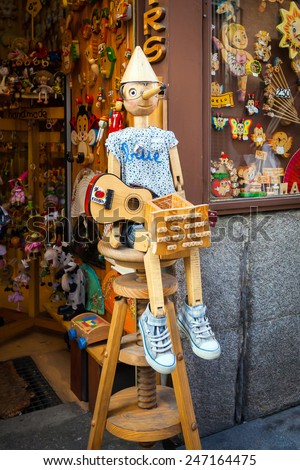 Madrid, Spain - May 6, 2012: Vintage wood toy shop with Pinocchio dool exposed on front in Madrid, Spain