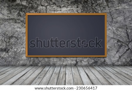 blackboard on wall with wooden table for design