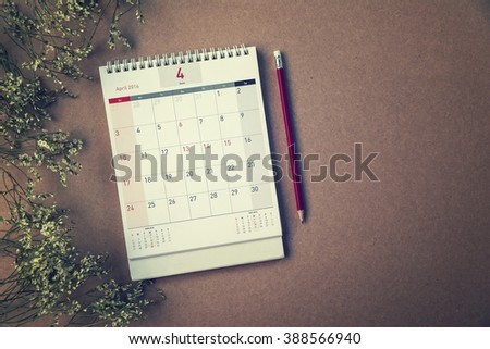 April Calendar 2016 and old flower on wood table ,vintage filter