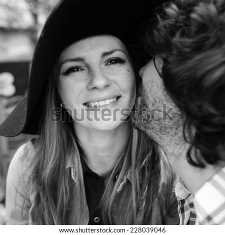 Black and white portrait of emotional young Italian couple in the park