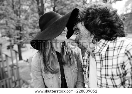 Black and white portrait of emotional young Italian couple in the park