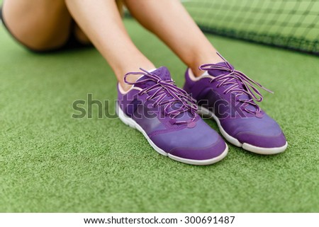 Running shoes on a tennis court background Athletic, health, sports, lifestyle.
