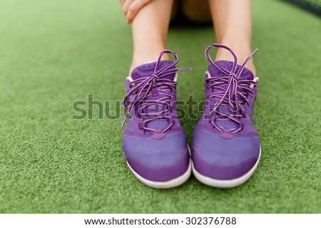 Running shoes on a tennis court background Athletic, health, sports, lifestyle.