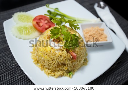 Baked rice with pineapple or Pineapple Fried Rice with Shrimp and dried shredded pork in white dish