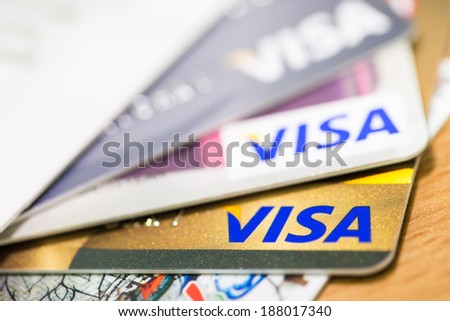 BANGKOK, THAILAND - February 27, 2014: Closeup of VISA credit card with smart ship on wood texture background. VISA is one of the three biggest brands.