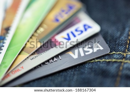 BANGKOK, THAILAND - March 24, 2014: Closeup of VISA credit card on blue denim jeans texture. VISA is one of the three biggest brands.