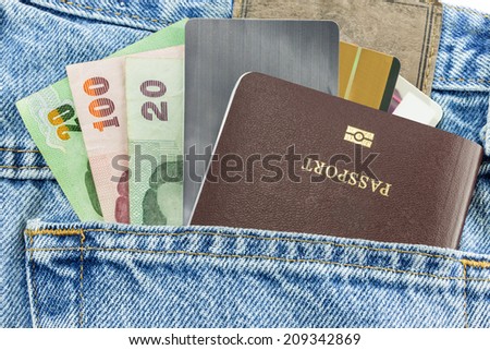 Closeup of credit card and passport in jeans in blue denim jeans pocket