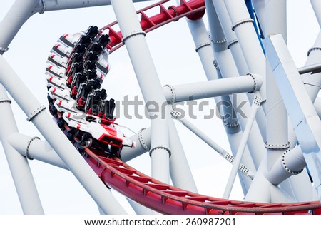 a roller coaster\'s loop with blue sky