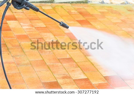 Outdoor floor cleaning and building cleaning with high pressure water jet.