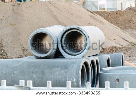 Wastewater, sewage pipes made of concrete at a construction site.