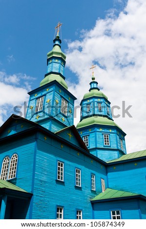 cupola of old wooden church on blue sky background