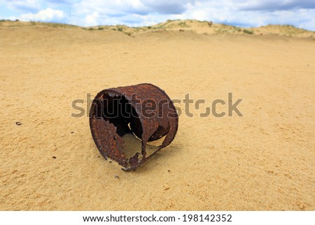 broken rusty can on sand
