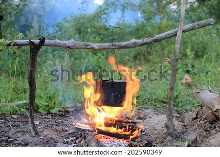 Smoked Tourist Kettle On Camp Fire Stock Photo, Picture and