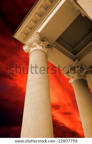 Antique columns on the dramatic red sky background