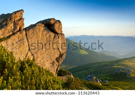 rock in Carpathian mountains lighted evening sky
