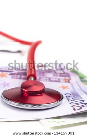 Red stethoscope close-up on top of euro bills